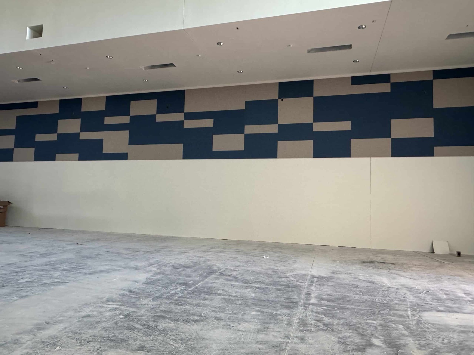 Patterned acoustic wall panels being installed in an education facility