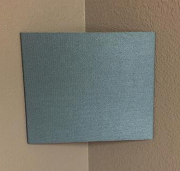 ACC-U-SOUND CBT fabric-finished panel mounted diagonally across an interior wall corner