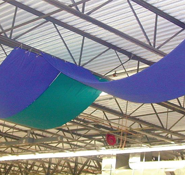 Blue and green low-density baffle banners suspended beneath open structure