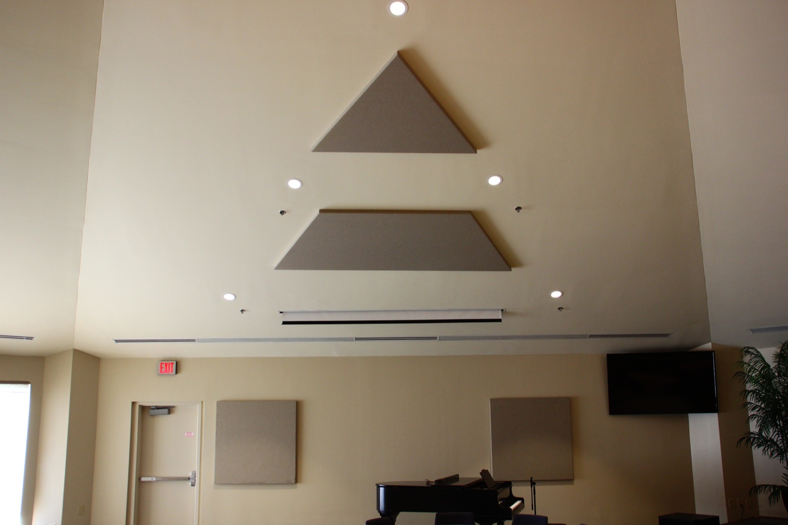 Triangular acoustic wall panels arranged in a finished commercial interior