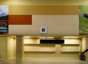 Color-block wall treatment coordinated with graphics around a service area.