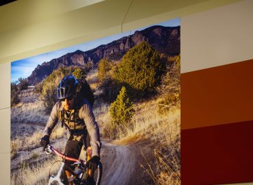 Orange and red wall panels beside a large outdoor photo mural.