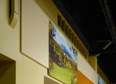 Landscape image panels integrated above doors and horizontal wall bands.