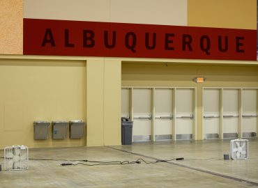 Acoustic wall panels and a red location sign above public entry doors.