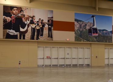 Music and landscape image panels integrated above a bank of doors.