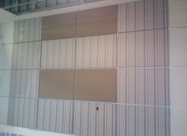 Pale vertical textured acoustic panels in a commercial interior.