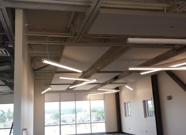 Angled suspended acoustic baffles coordinated with linear lighting.