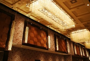 Ornate performance space with sculptural ceiling and dark acoustic wall panels.