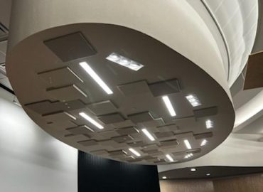 Circular ceiling feature with gray panels and linear lighting.