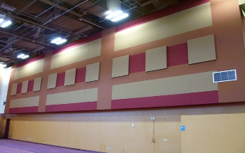 Pink and gray wall panels arranged across a large gymnasium.