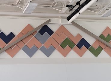 Peach, blue and green chevron panels around basketball equipment.