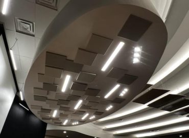 Close view of gray acoustic panels mounted to a circular ceiling feature.